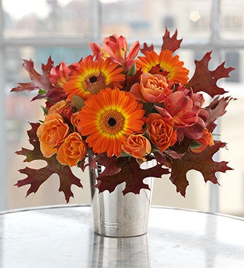 Brilliant orange Gerbera daisies in julep cup
