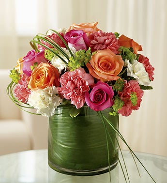 roses and carnations in glass cylinder